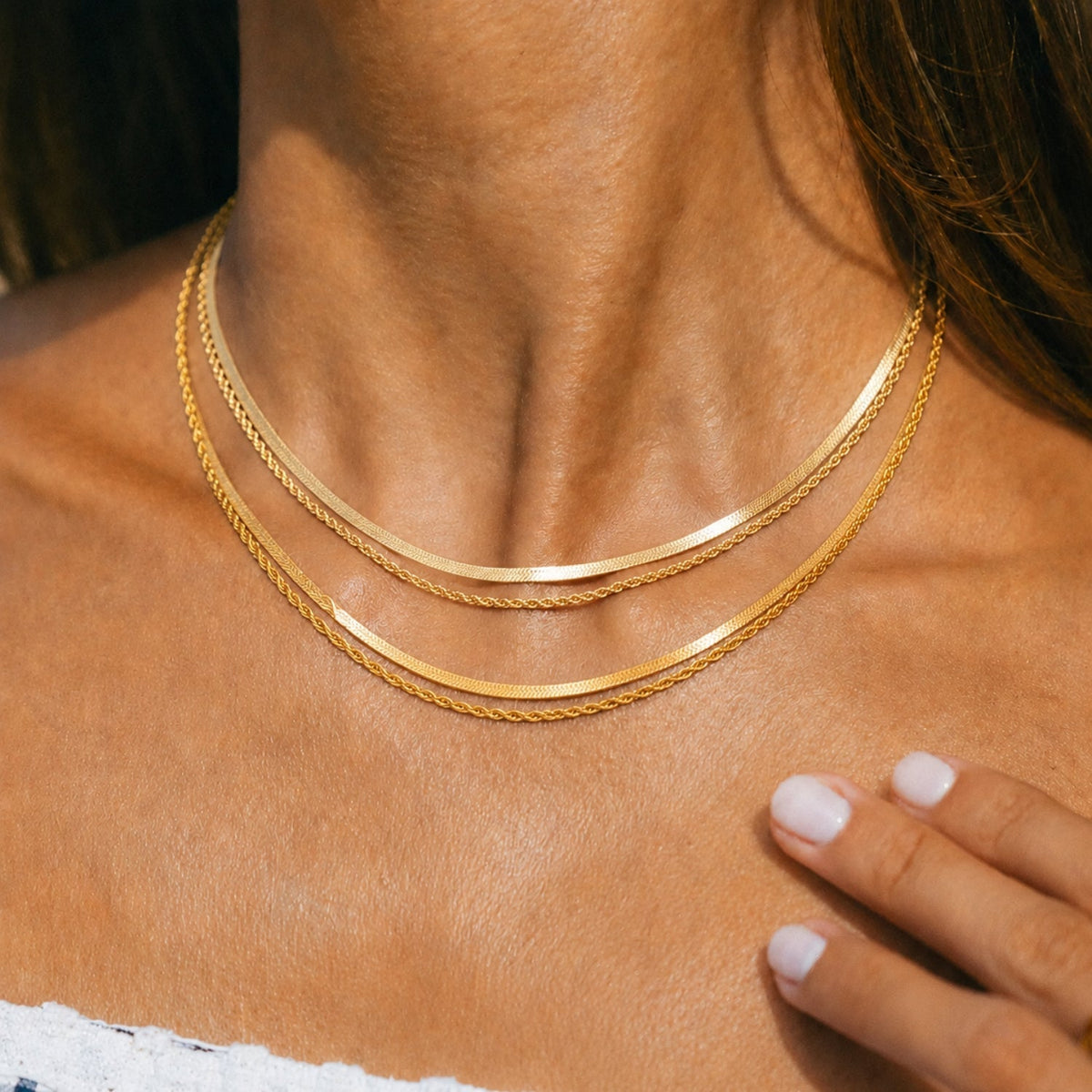 Colar em camadas da Mari Gavane com acabamento dourado 14k, mostrando detalhes delicados e design elegante.